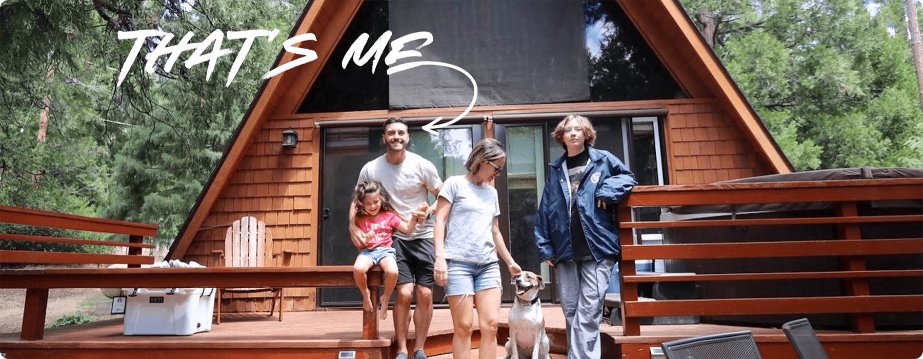 Tony with his family and dog outside their A-frame cabin