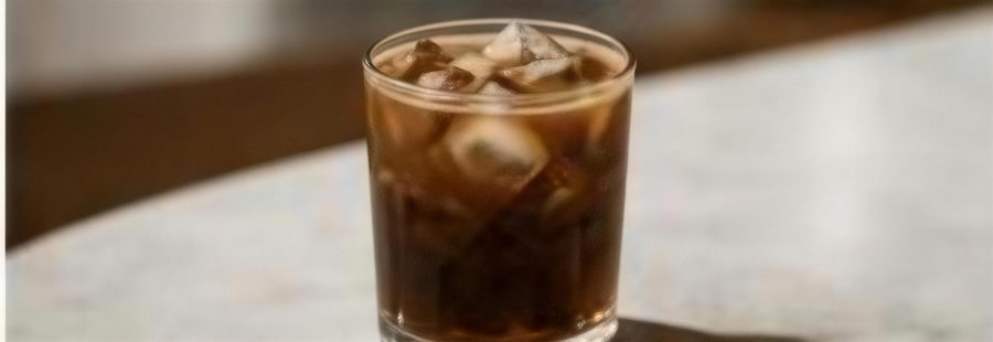 Iced coffee in a clear glass catching the afternoon light