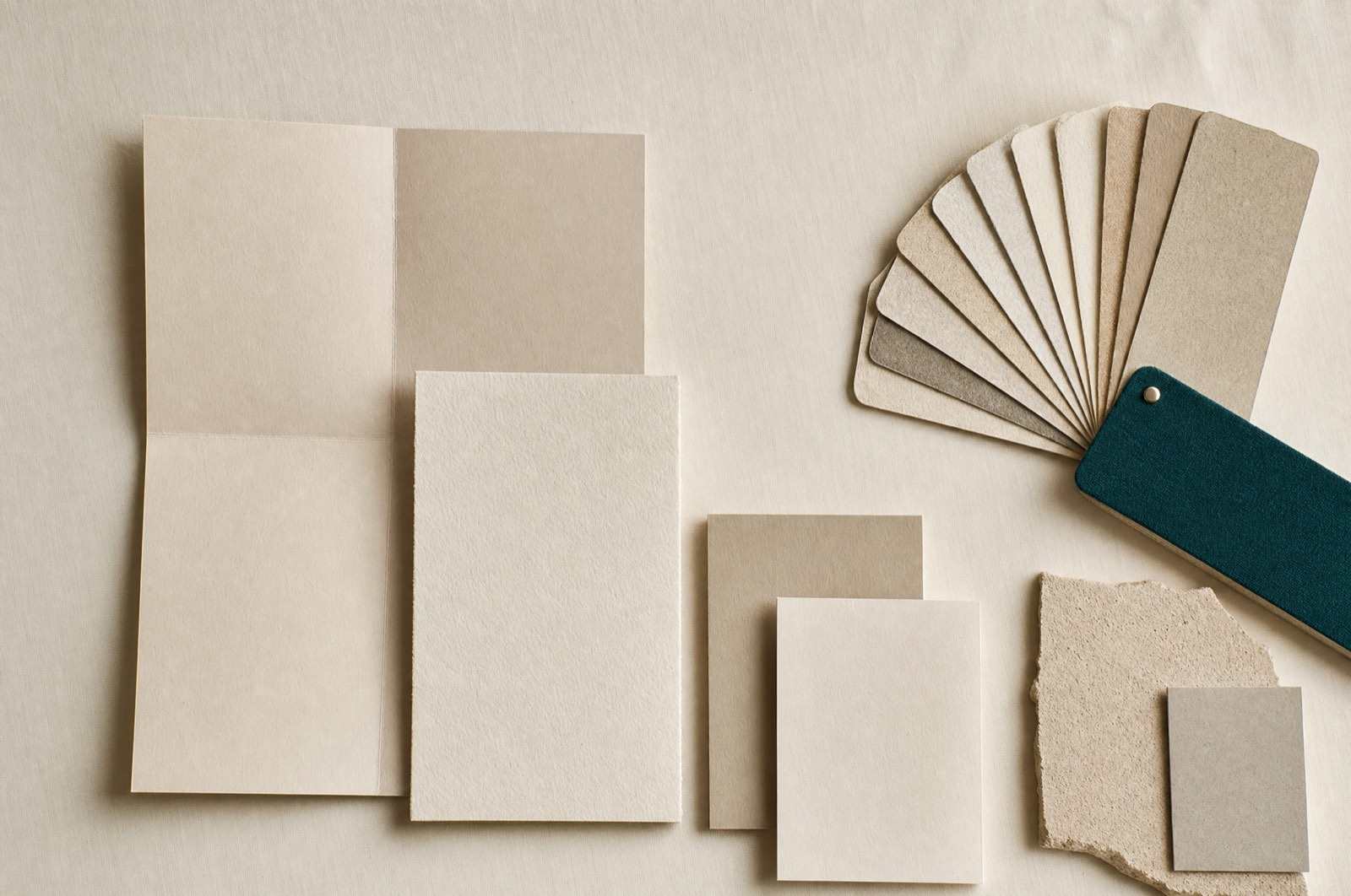 Overhead flat lay of blank printed brand collateral arranged on a grid