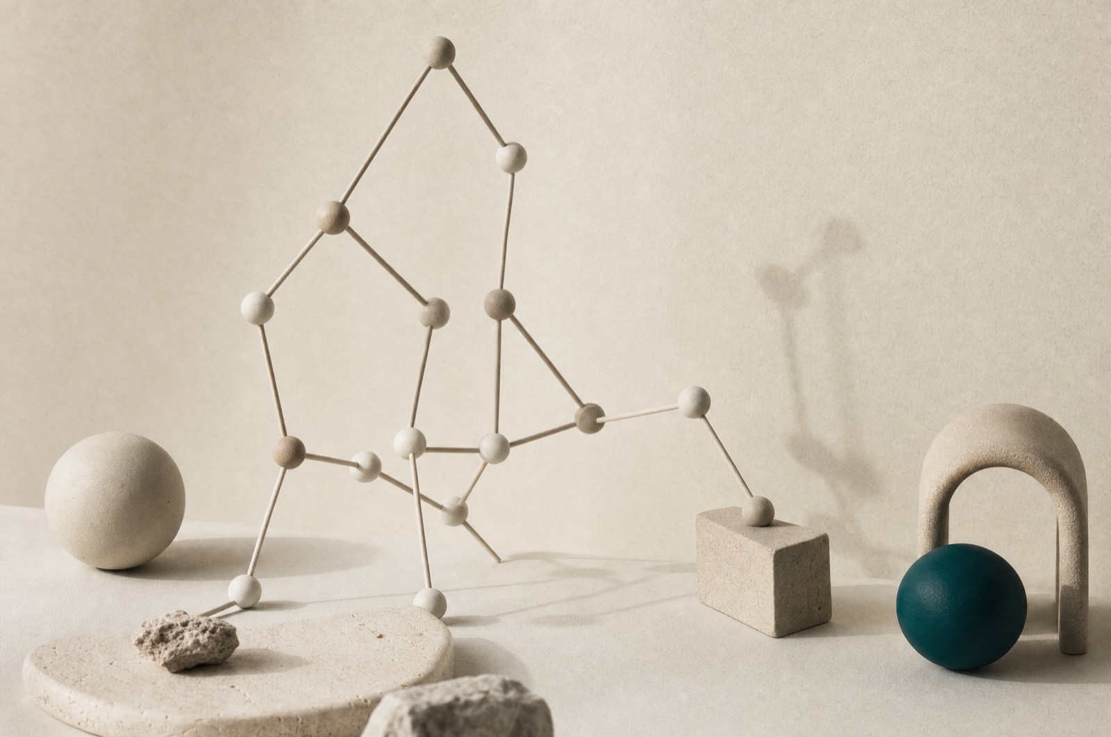Abstract sculpture of slender connected rods and spherical joints casting soft shadows