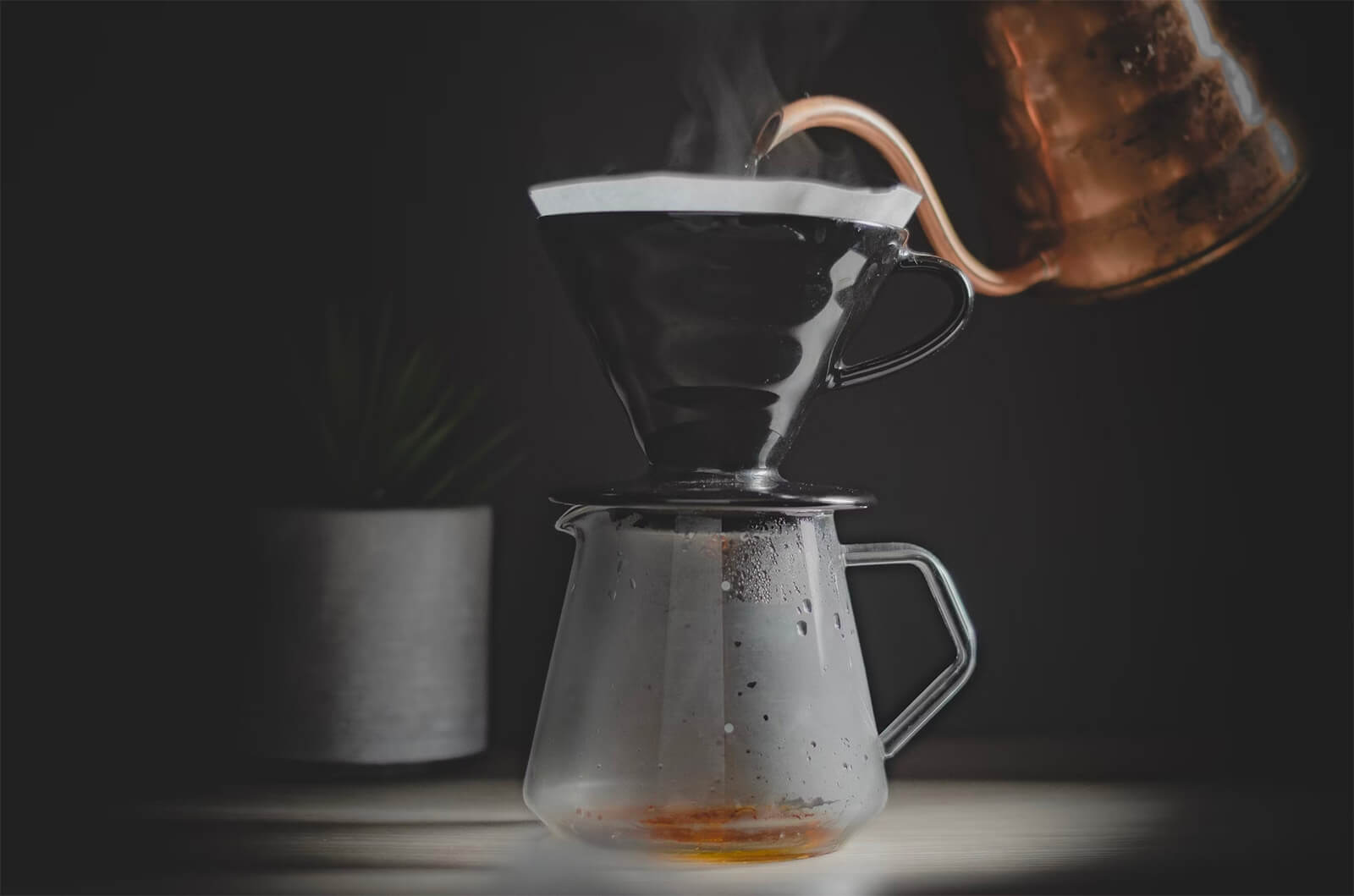 A pour-over coffee mid-brew, water spiraling over the grounds