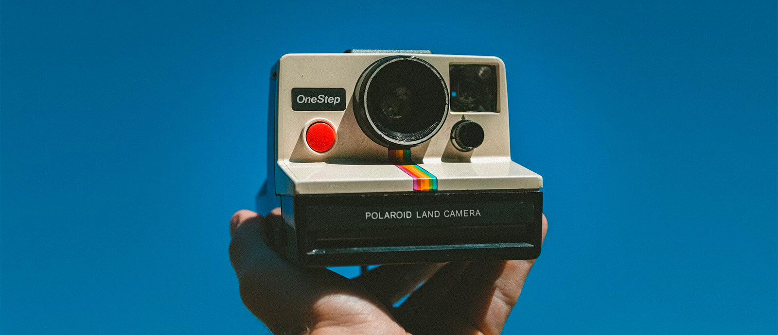 A collection of vintage technology arranged on a wooden desk