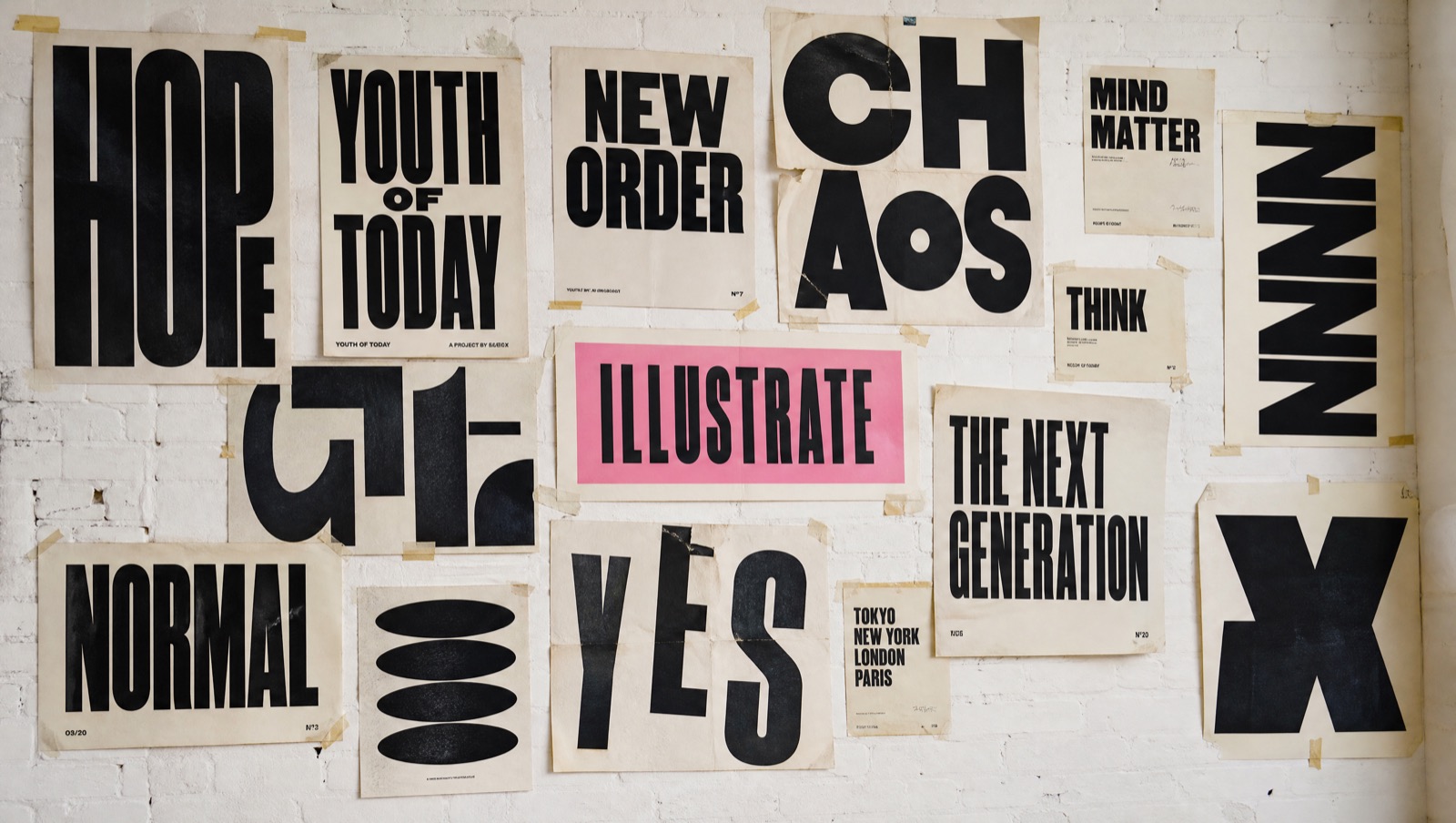 A poster wall of loud typographic experiments
