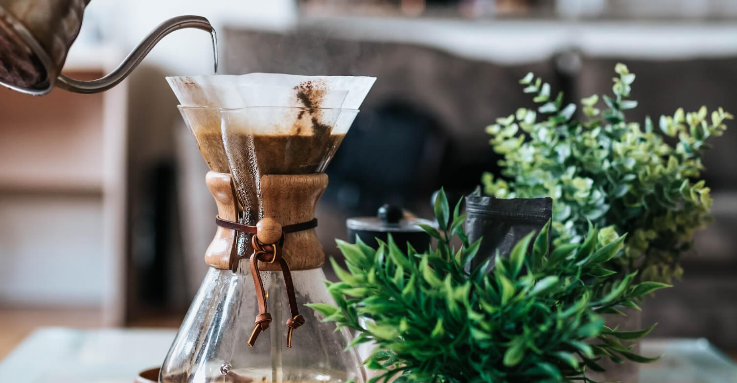 A pour-over coffee brewing in soft morning light