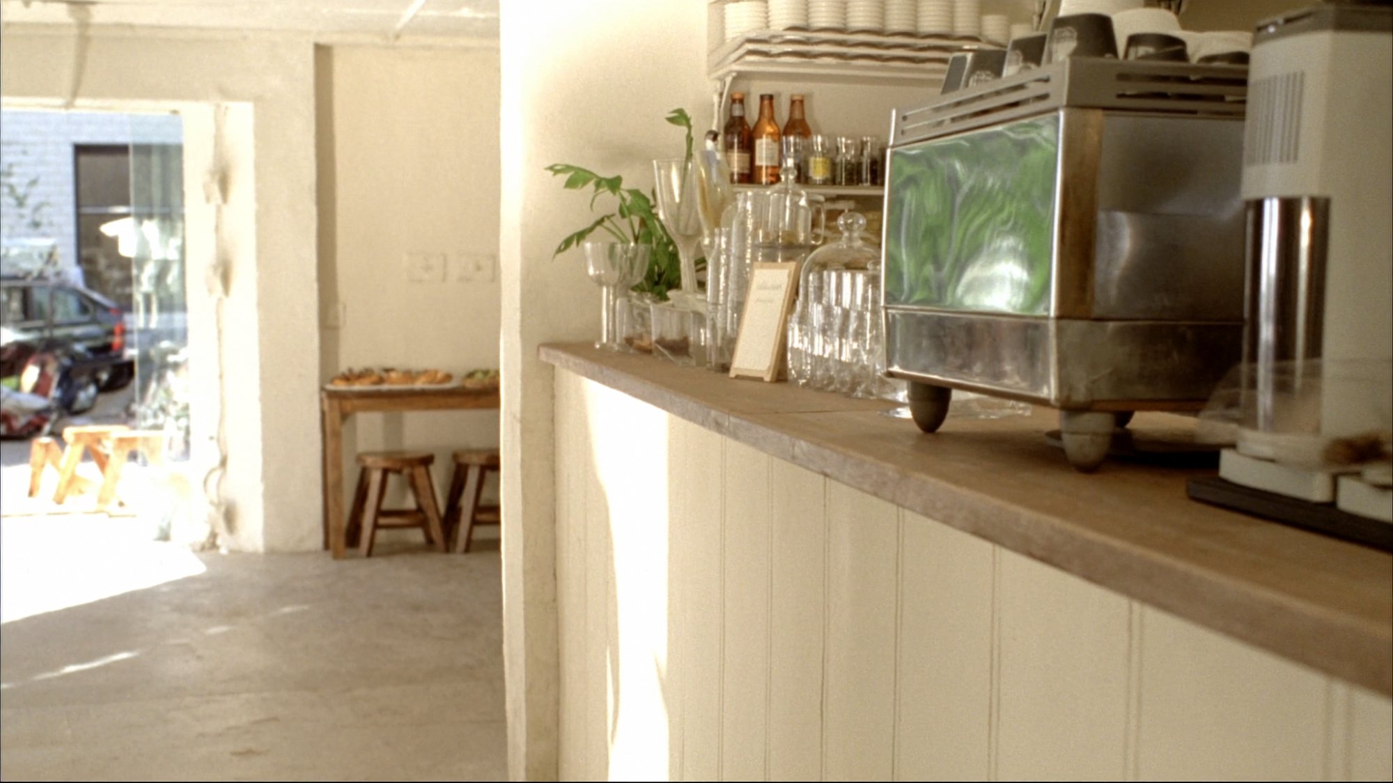 The coffee bar in the late afternoon, sun across the counter