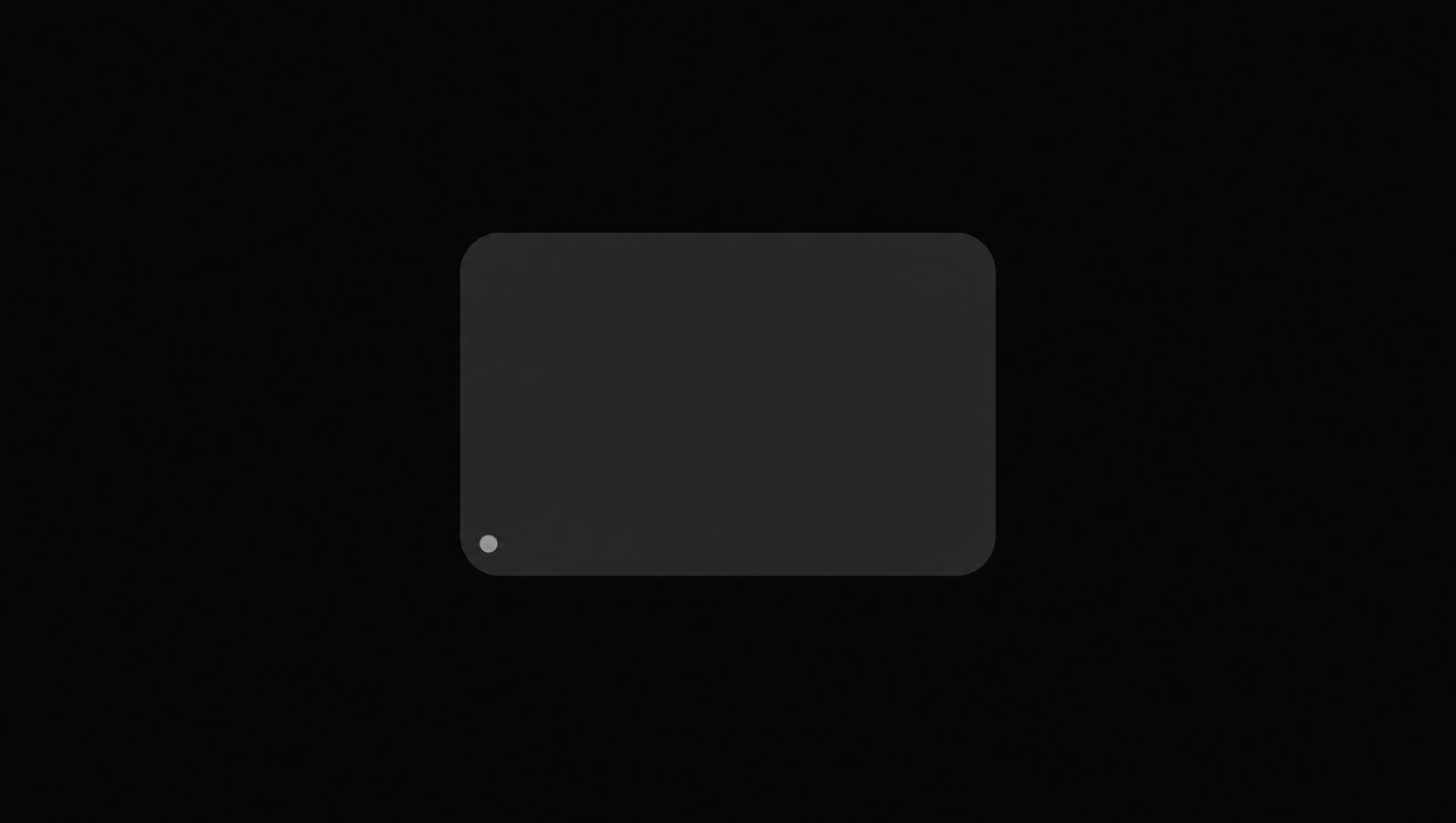 A plain charcoal panel with a single small clay dot in one corner