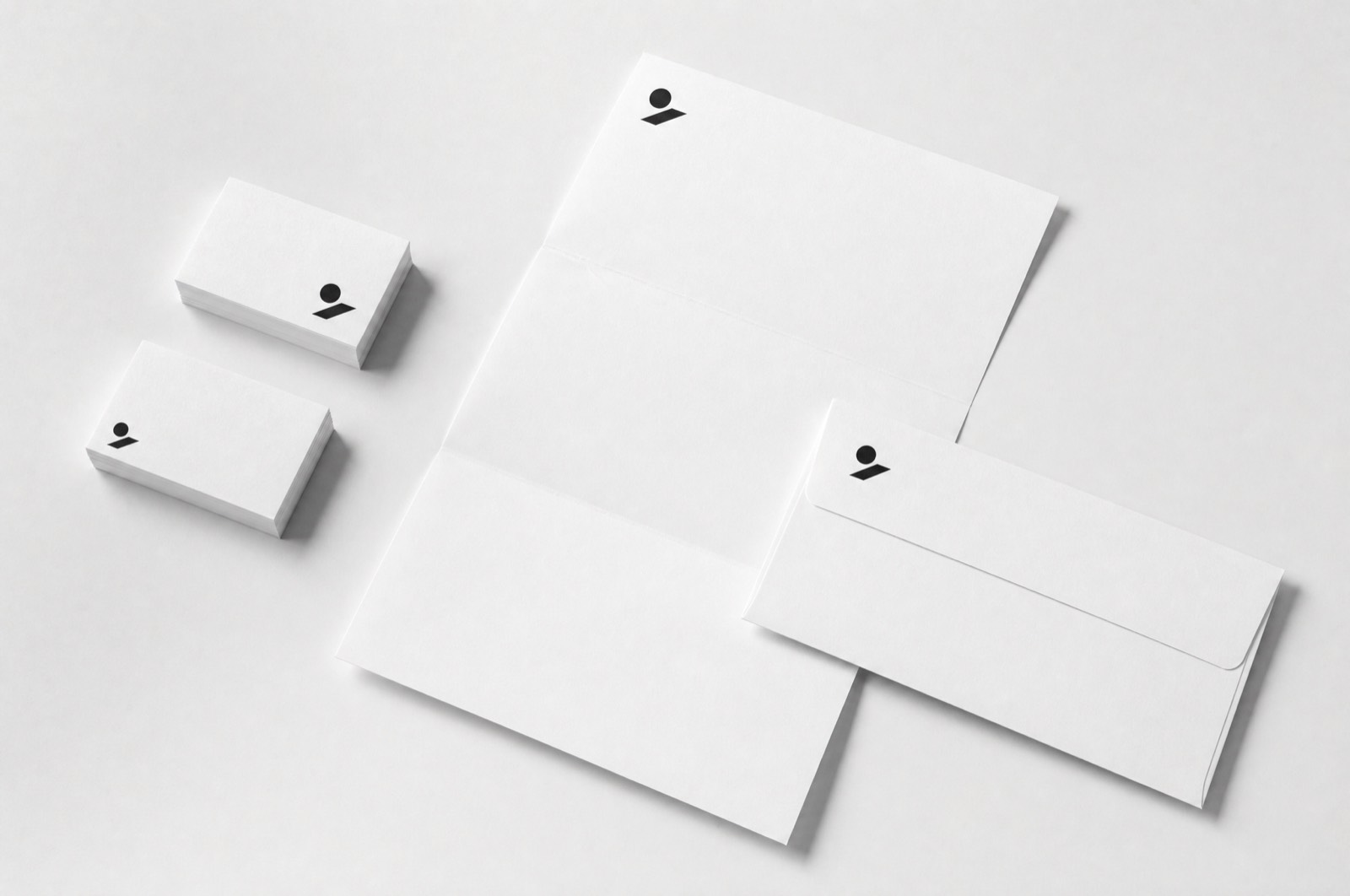 Ledger stationery — business cards, letterhead and an envelope carrying a small mark