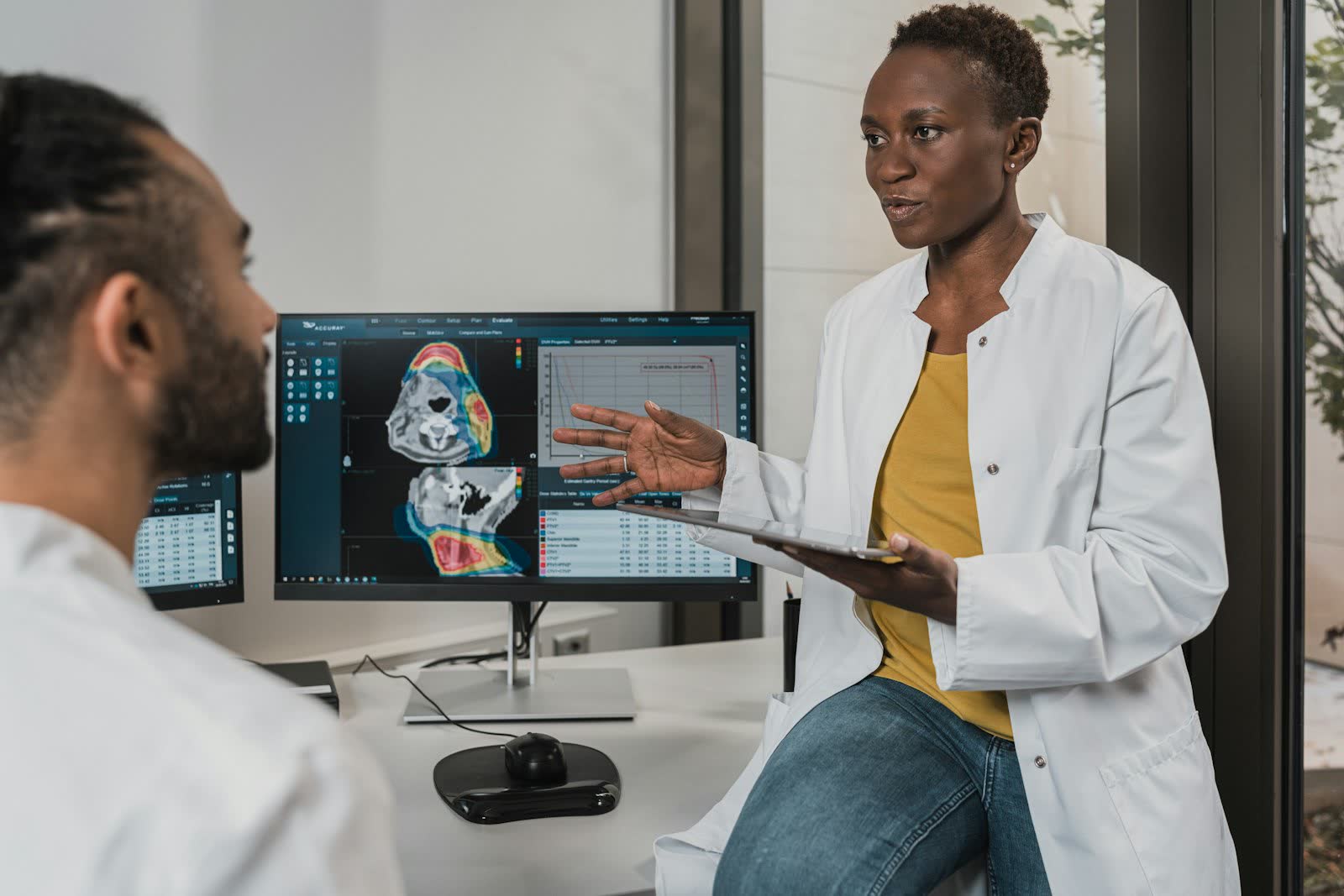 A clinician walking a colleague through results on screen