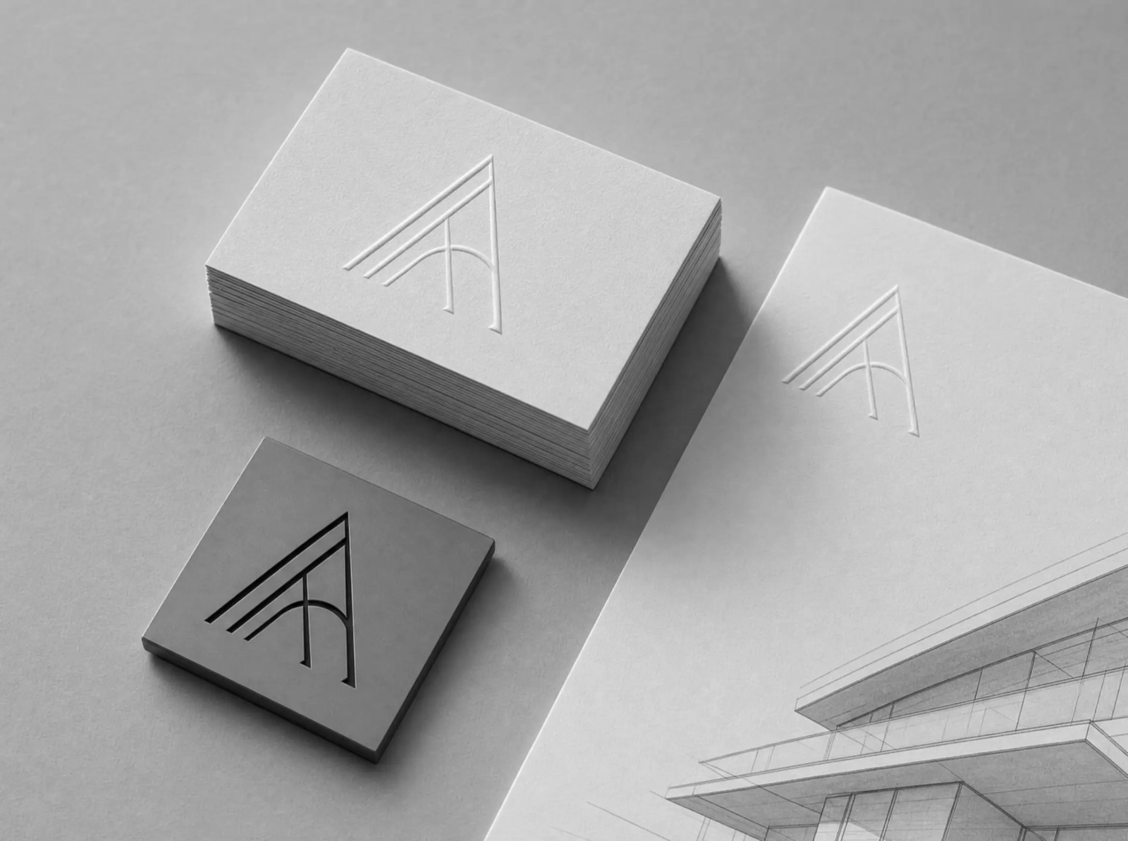 Halden brand identity — embossed business cards and letterhead on gray paper